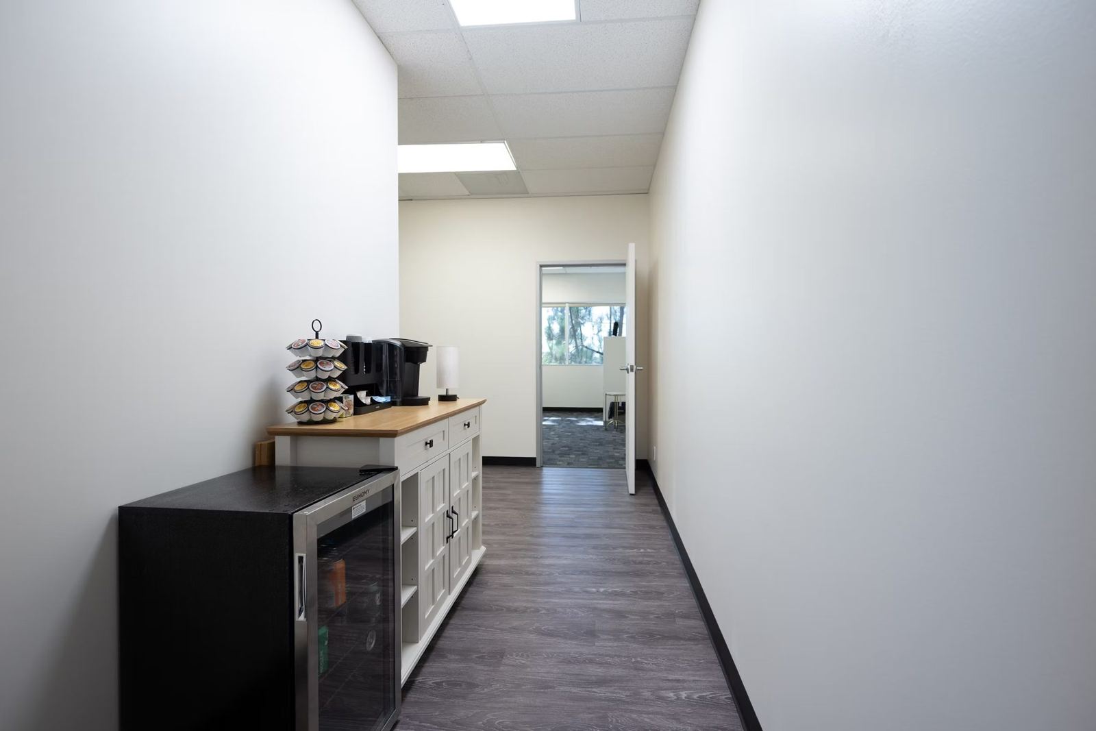 Hallway refreshment station with coffee machine and drinks fridge