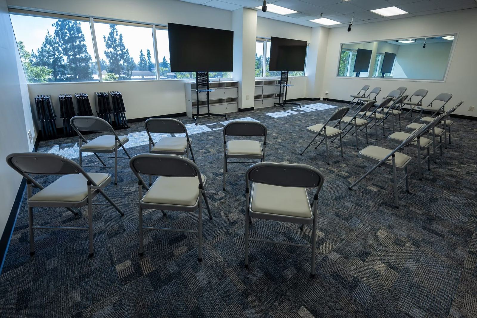 Suite A with rows of chairs facing screens