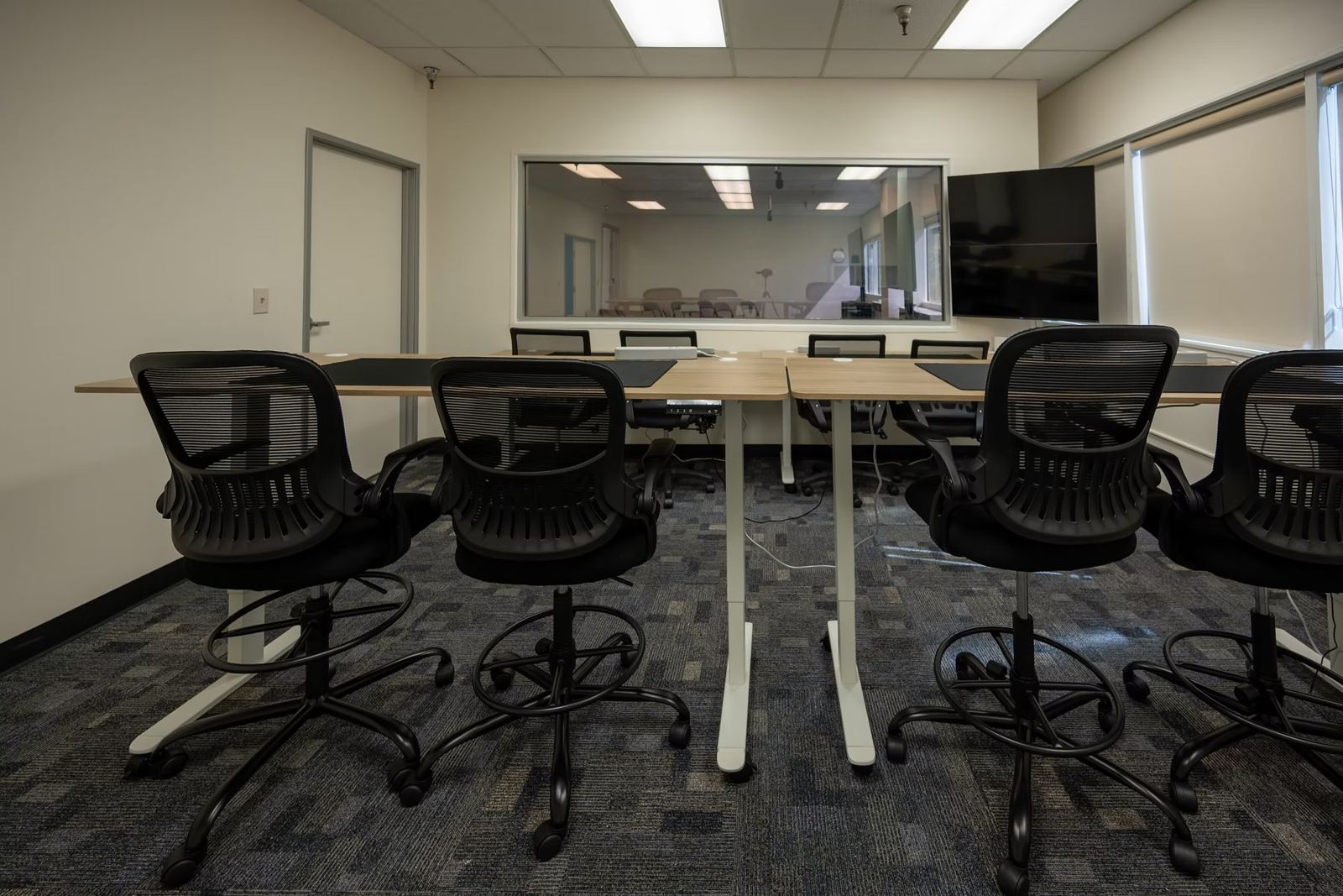 Viewing room with tall chairs facing the one-way mirror