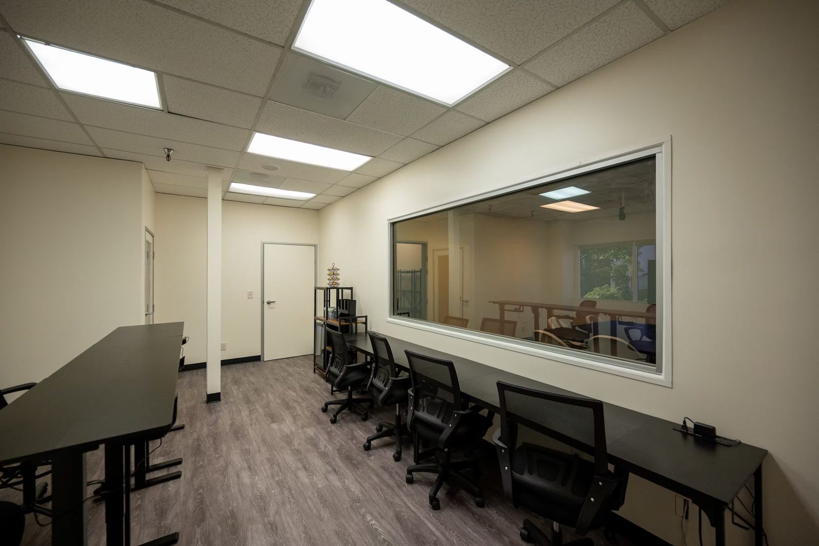 Suite B viewing room with desks facing the one-way mirror